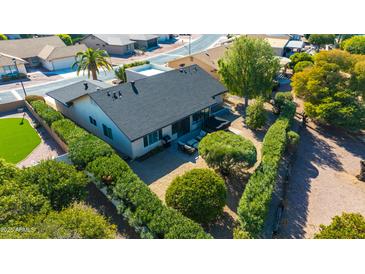 Aerial view of a home with a spacious backyard, lush landscaping, and a patio at 814 S 78Th St, Mesa, AZ 85208