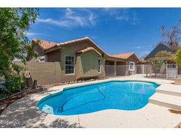 Inviting backyard with a refreshing blue pool, ideal for relaxation and entertainment at 8773 W Pineveta Dr, Arizona City, AZ 85123