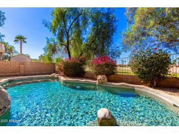 Inviting kidney-shaped pool surrounded by lush landscaping at 968 S Western Skies Dr, Gilbert, AZ 85296