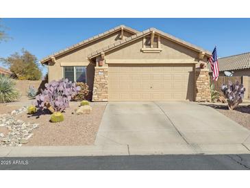 Charming single-story home with desert landscaping, neutral tones, and a spacious two-car garage at 10282 E Trailhead Ct, Gold Canyon, AZ 85118