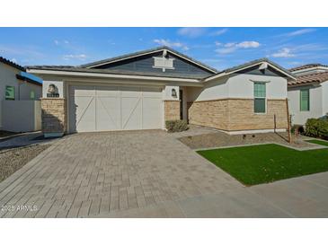 One-story home with stone accents and a two-car garage at 11444 N Northfield St, Surprise, AZ 85388