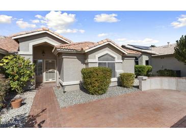 Charming single-story home with a well-maintained front yard and a welcoming entrance at 15406 W Pinchot Ct, Goodyear, AZ 85395