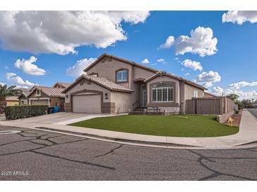 Two-story house with a landscaped yard and attached garage at 2407 E Taro Ln, Phoenix, AZ 85050