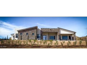 Stunning modern home with stone accents and expansive windows at 42434 N Tonto Rd, Cave Creek, AZ 85331