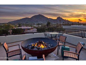 Relax on this rooftop patio with a fire pit, mountain views, and an outdoor seating area perfect for entertaining at 5826 E Indian Bend Rd, Paradise Valley, AZ 85253
