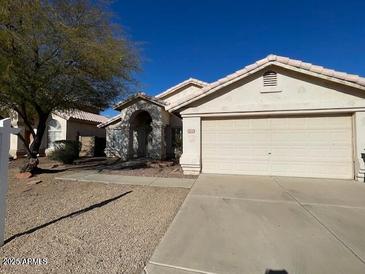 Single-story house with a two-car garage and desert landscaping at 1324 W Michigan Ave, Phoenix, AZ 85023