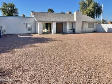 Large backyard with gravel and a storage shed at 1714 N Pleasant Dr, Chandler, AZ 85225