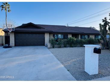 Ranch style home with a two-car garage and mature landscaping at 2401 E Christy Dr, Phoenix, AZ 85028