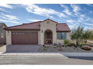 Single-story home with brown garage door and nicely landscaped front yard at 26861 W Adam Ave, Buckeye, AZ 85396