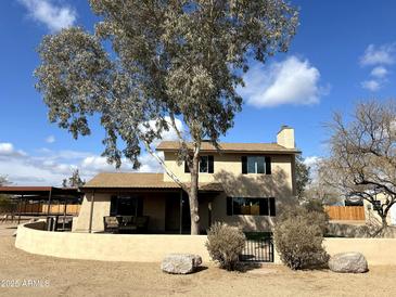 Two-story house with tan exterior, brown roof, and landscaped yard at 36014 N 3Rd St, Phoenix, AZ 85086