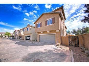 Two-story home featuring a 2-car garage, desert landscaping, and neutral paint at 3883 E Santa Fe Ln, Gilbert, AZ 85297