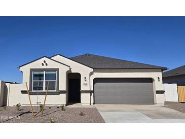 One-story house with gray garage door and desert landscaping at 5422 E Rock Bush Ln, San Tan Valley, AZ 85140