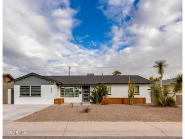 Charming single-story home boasts a well-maintained yard with desert landscaping and a freshly painted exterior at 8024 E Hubbell St, Scottsdale, AZ 85257