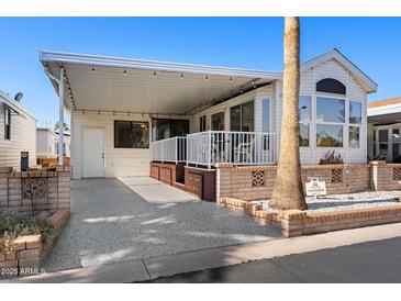 Inviting exterior of manufactured home with covered patio and landscaping at 111 S Greenfield Rd # 488, Mesa, AZ 85206