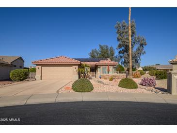 Single-story home with a tile roof, landscaped yard, and two-car garage at 15666 W Arbor Trl, Surprise, AZ 85374