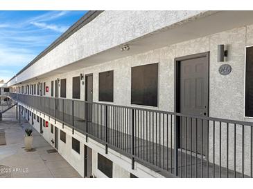 Exterior view of apartment building with walkway and railings at 18202 N Cave Creek Rd # 241, Phoenix, AZ 85032