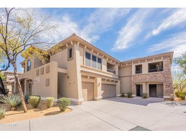 Beautiful multi-level home with stone accents, desert landscaping, and a private two-car garage at 19700 N 76Th St # 2072, Scottsdale, AZ 85255