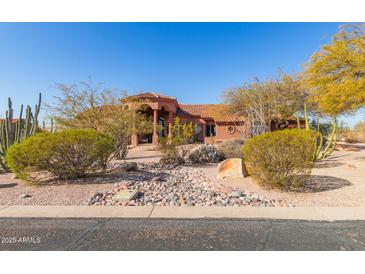 Stunning desert landscape surrounds this single-story home with a terracotta tile roof at 8540 E Mcdowell Rd # 55, Mesa, AZ 85207