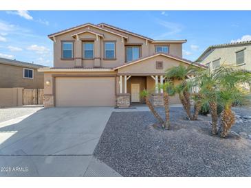 Two-story house with a three-car garage and desert landscaping at 1179 E Coyote Creek Way, San Tan Valley, AZ 85143