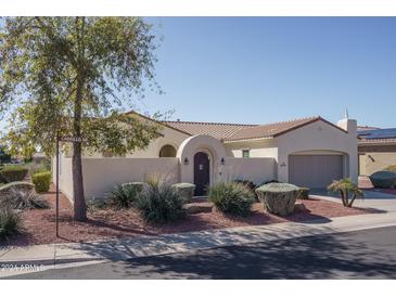 Single-story home with arched entryway and landscaped yard at 13403 W Cabrillo Dr, Sun City West, AZ 85375