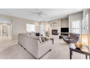 Spacious living room with fireplace and ample natural light at 19700 N 76Th St # 1112, Scottsdale, AZ 85255