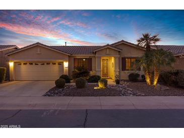 Well-maintained house with a landscaped front yard, two-car garage, and inviting entryway at 20208 N Oxbow Ln, Maricopa, AZ 85138