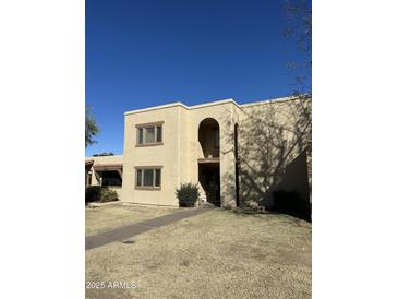 Two-story building exterior with tan stucco and arched entryway at 2108 E Dunbar Dr, Tempe, AZ 85282