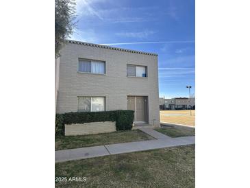 Tan brick building with double doors and landscaping at 225 N Standage St # 104, Mesa, AZ 85201