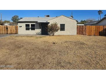 Cozy single-story home with a neutral-toned exterior and a well-kept front yard at 2324 W Luke Ave, Phoenix, AZ 85015