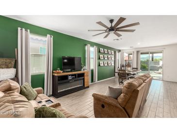 Spacious living room featuring a fireplace and ample natural light at 2427 W Kowalsky Ln, Phoenix, AZ 85041