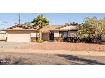 Single story home with attached garage and desert landscaping at 2715 S Rita Ln, Tempe, AZ 85282