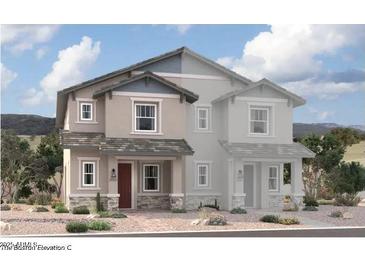 Two-story home with gray siding, red door, and stone accents at 2838 N Evergreen St, Buckeye, AZ 85396