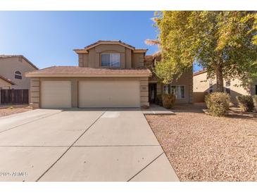 Two-story house with a three-car garage and landscaped front yard at 31292 N Candlewood Dr, San Tan Valley, AZ 85143