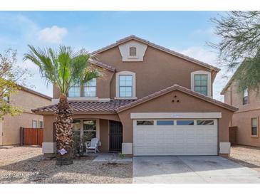 Charming two-story home features a two-car garage, desert landscaping, and a cozy front porch at 3209 W Apollo Rd, Phoenix, AZ 85041