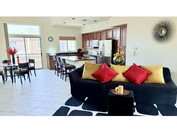 Open floor plan with kitchen island, stainless steel appliances, and living area at 3935 E Rough Rider Rd # 1191, Phoenix, AZ 85050