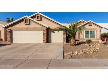 Beautiful two-story home with a landscaped front yard and two-car garage at 4220 E Thistle Landing Dr, Phoenix, AZ 85044