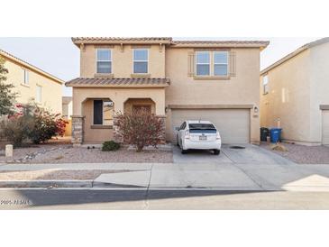 Two-story house with attached garage and desert landscaping at 7411 W Alta Vista Rd, Laveen, AZ 85339