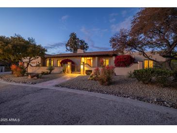 Stunning Southwestern-style home with beautifully landscaped grounds at 8502 E Country Club Trl, Scottsdale, AZ 85255