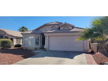 Single-story house with a two-car garage and desert landscaping at 9215 W Sandra Ter, Peoria, AZ 85382