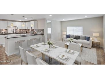 Open-concept living space with modern kitchen, dining area, and comfortable living room featuring bright natural light at 104 N 114Th St, Apache Junction, AZ 85120