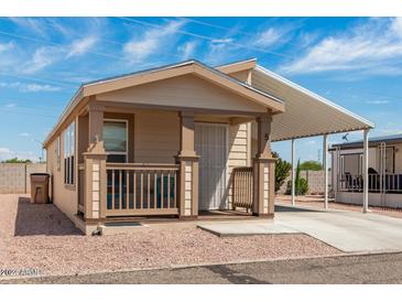 Single-wide manufactured home with carport and small front porch at 11596 W Sierra Dawn Blvd # 5, Surprise, AZ 85378