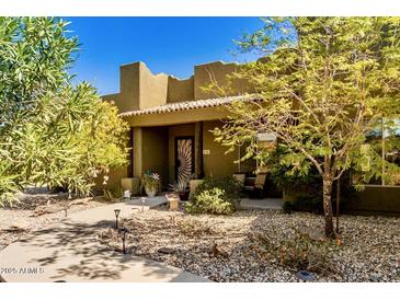 Desert landscaping and stucco exterior of a single-story home at 210 W Yucca Ln, New River, AZ 85087