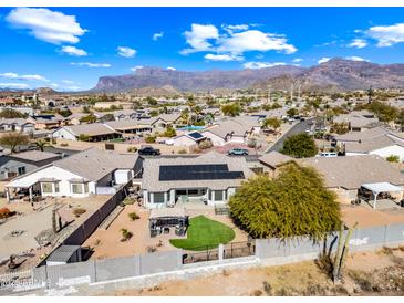 Expansive aerial view of a property with desert landscaping, solar panels, and mountain views at 8479 E Sunrise Sky Dr, Gold Canyon, AZ 85118