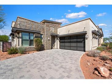 Craftsman style home with stone accents and a 3-car garage at 15957 E Ridgestone Dr, Fountain Hills, AZ 85268