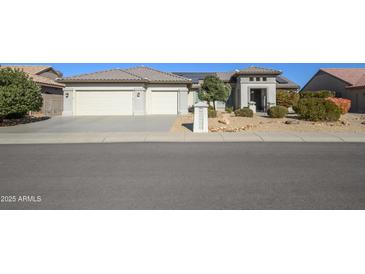 Single-story home with a two-car garage and desert landscaping at 16442 W Quarry Ct, Surprise, AZ 85374