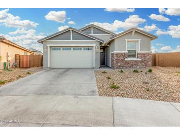 One-story home with a two-car garage and stone accents at 19457 W Highland Ave, Litchfield Park, AZ 85340