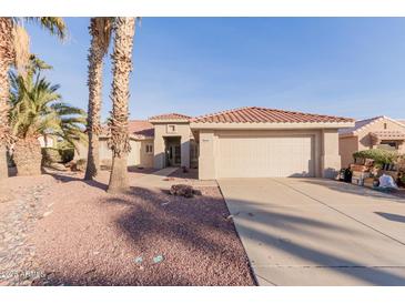 Charming single-story home with a red tile roof, desert landscaping and a spacious two-car garage at 22801 N Las Vegas Dr, Sun City West, AZ 85375