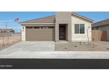 Charming single-story home featuring a neutral palette and a well-manicured, drought-resistant front yard at 24248 W Agora Ln, Buckeye, AZ 85326