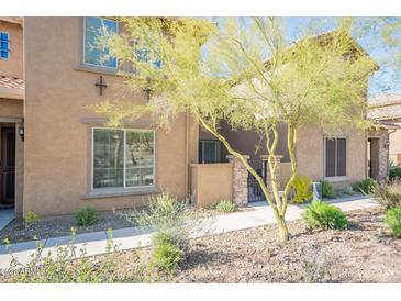 Tan stucco home with a landscaped front yard and walkway at 28731 N 20Th Ln, Phoenix, AZ 85085