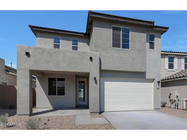 Two-story house with gray exterior, white garage door, and desert landscaping at 34690 N Ashwood Dr, San Tan Valley, AZ 85144